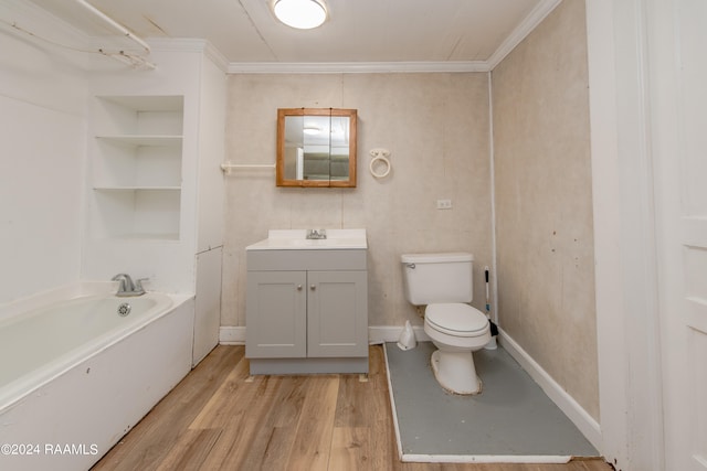 bathroom with toilet, crown molding, hardwood / wood-style floors, a bath to relax in, and vanity