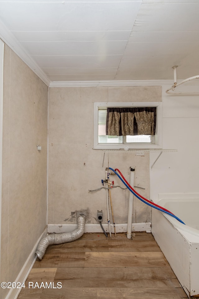 laundry room featuring ornamental molding, hardwood / wood-style floors, and hookup for a washing machine