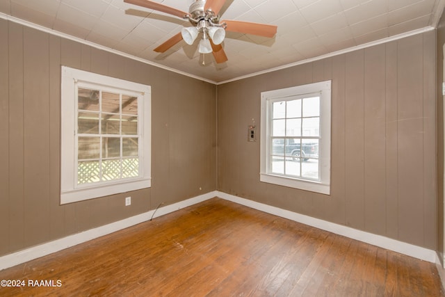 spare room featuring ceiling fan, crown molding, and dark wood-type flooring