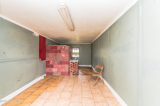 interior space featuring ornamental molding and light tile flooring