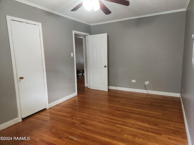 interior space with ornamental molding, hardwood / wood-style flooring, and ceiling fan