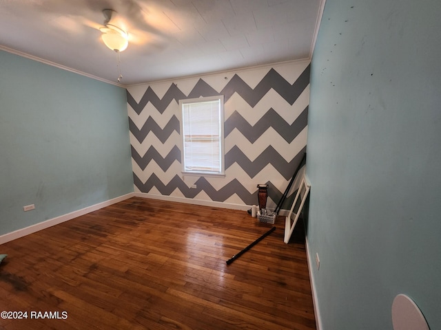 spare room with ornamental molding, wood-type flooring, and ceiling fan