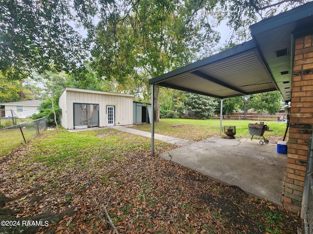 view of yard featuring an outbuilding and a patio area