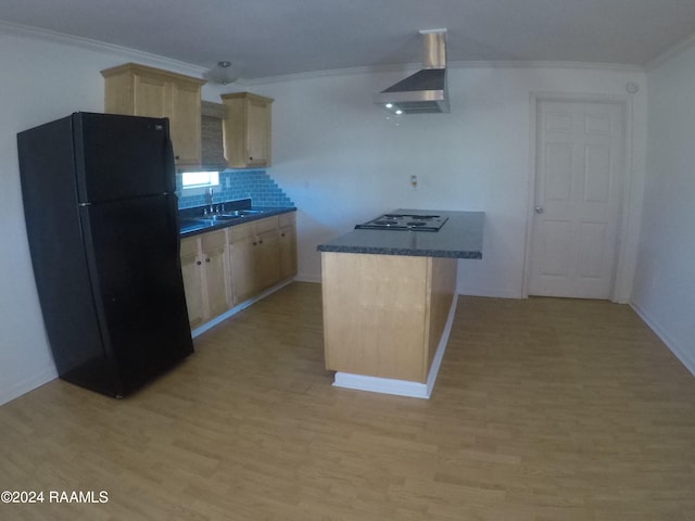 kitchen featuring black fridge, wall chimney exhaust hood, light brown cabinetry, tasteful backsplash, and light hardwood / wood-style floors