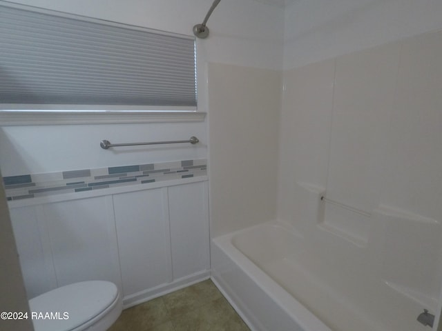 bathroom with toilet and shower / washtub combination