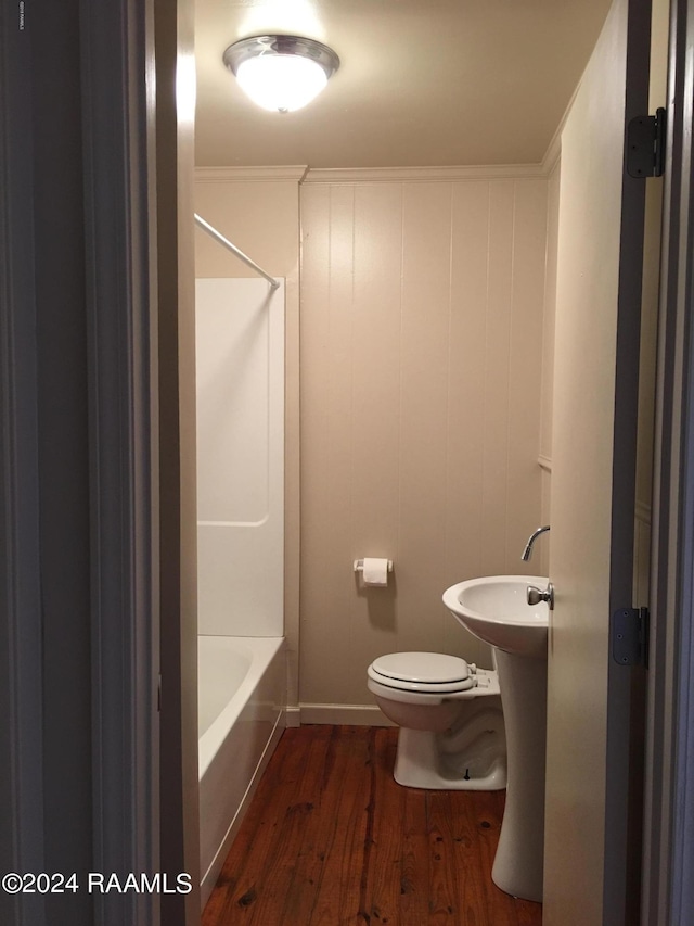 bathroom featuring hardwood / wood-style floors, ornamental molding, and toilet