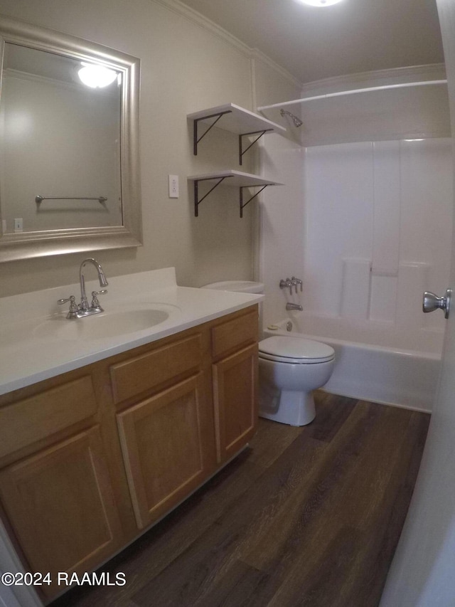 full bathroom featuring ornamental molding, shower / bath combination, toilet, vanity, and hardwood / wood-style flooring