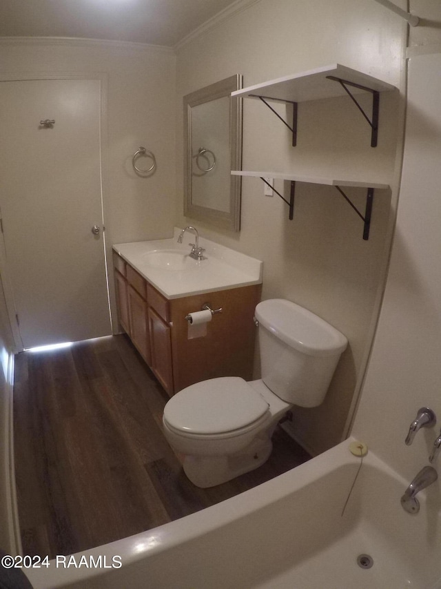 bathroom featuring vanity, crown molding, a shower, hardwood / wood-style floors, and toilet