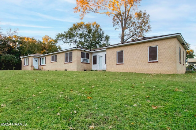 rear view of property with a yard