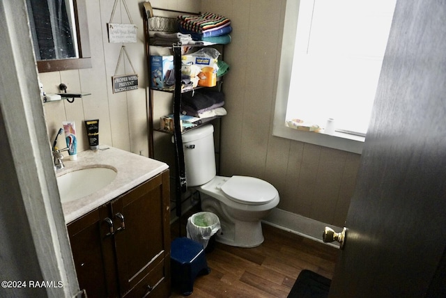 bathroom with vanity, hardwood / wood-style flooring, and toilet