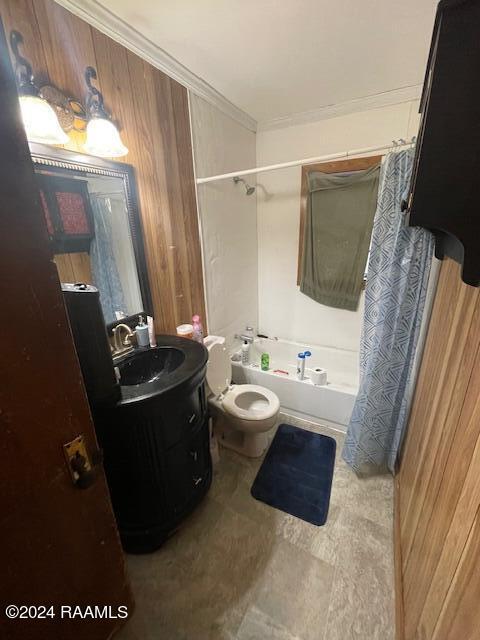 full bathroom featuring tile floors, wood walls, shower / tub combo, toilet, and vanity