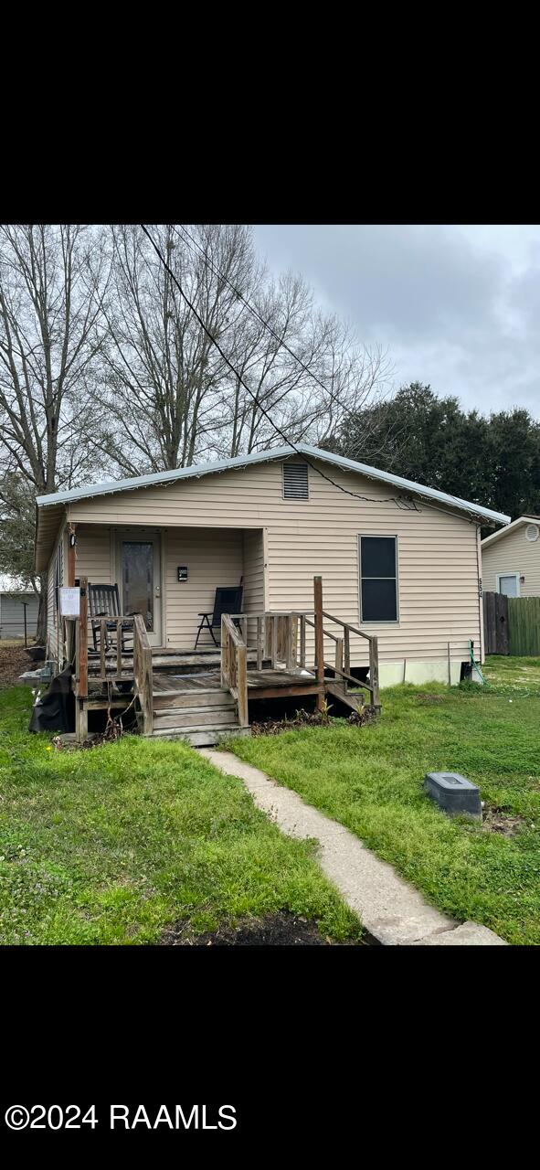 back of house with a yard and a deck