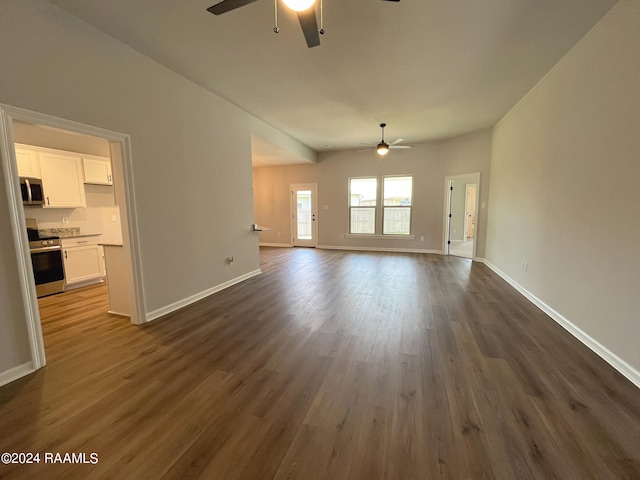 unfurnished living room with ceiling fan and dark hardwood / wood-style flooring