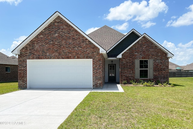 view of front of home with a front lawn and a garage