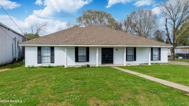 ranch-style house featuring central AC and a front lawn