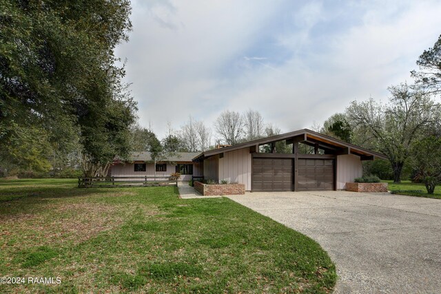 single story home with a front lawn and a garage