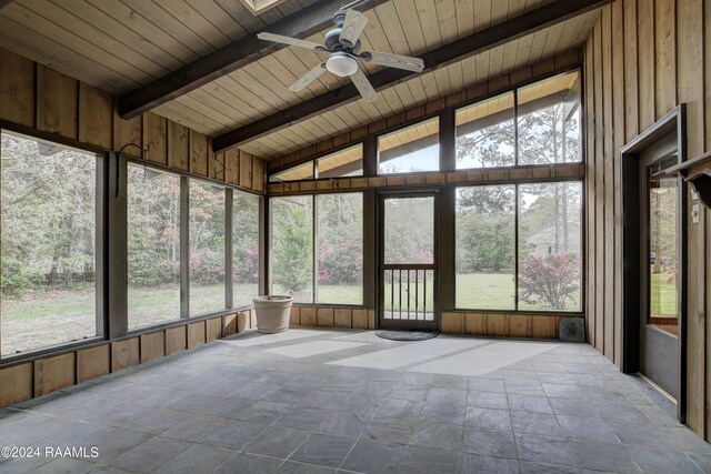 unfurnished sunroom featuring wooden ceiling, ceiling fan, and lofted ceiling with beams