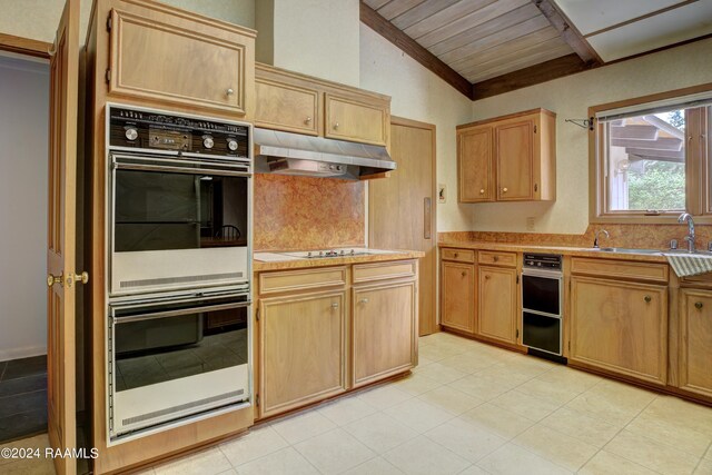 kitchen with double oven, sink, light tile floors, vaulted ceiling, and wood ceiling