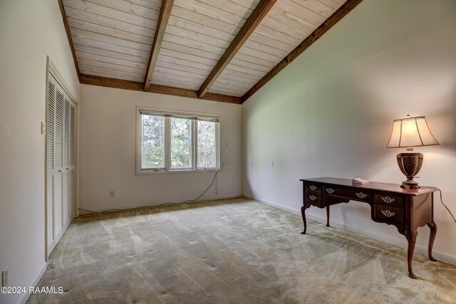 interior space with light colored carpet and lofted ceiling with beams