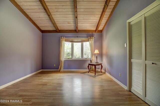 interior space with wooden ceiling, a closet, hardwood / wood-style flooring, and lofted ceiling with beams