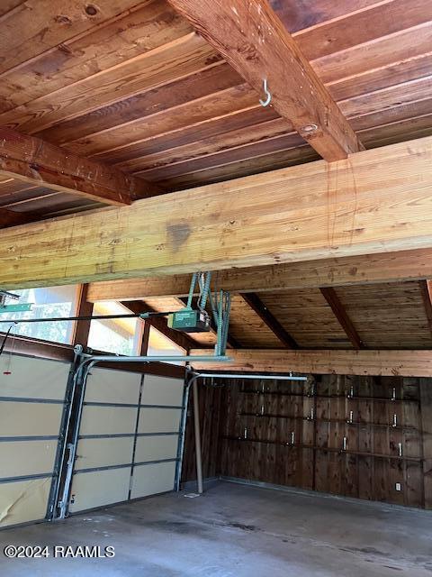 interior space featuring wood ceiling and a garage door opener