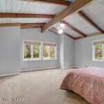 unfurnished bedroom featuring lofted ceiling with beams