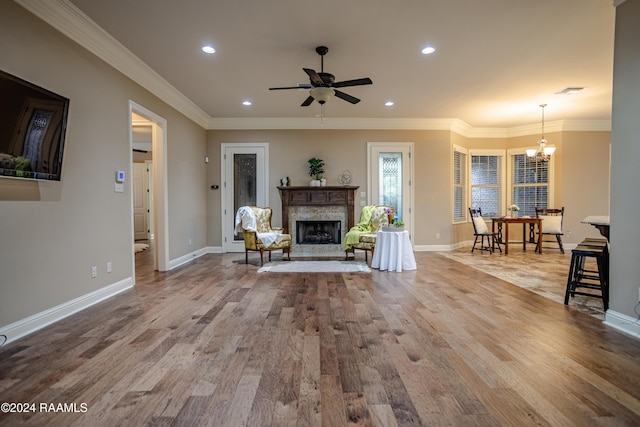 100 Giverny Pl, Lafayette, LA 70508 - living room with a chandelier, a fireplace with raised hearth, recessed lighting, a ceiling fan, and wood finished floors