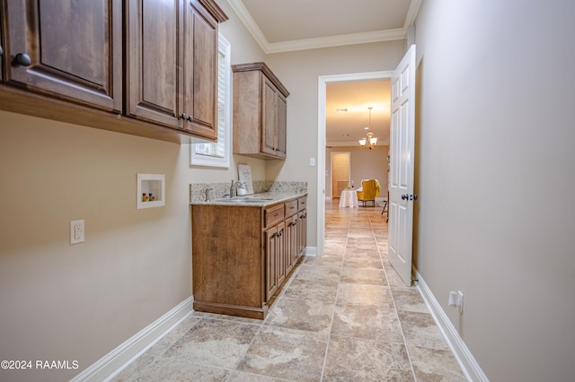 100 Giverny Pl, Lafayette, LA 70508 - washroom featuring cabinet space, washer hookup, crown molding, and light stone finish flooring