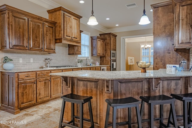 100 Giverny Pl, Lafayette, LA 70508 - kitchen with decorative backsplash, a peninsula, light stone countertops, decorative light fixtures, and a breakfast bar