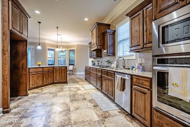 100 Giverny Pl, Lafayette, LA 70508 - kitchen featuring stainless steel appliances, decorative backsplash, a chandelier, light stone countertops, and pendant lighting