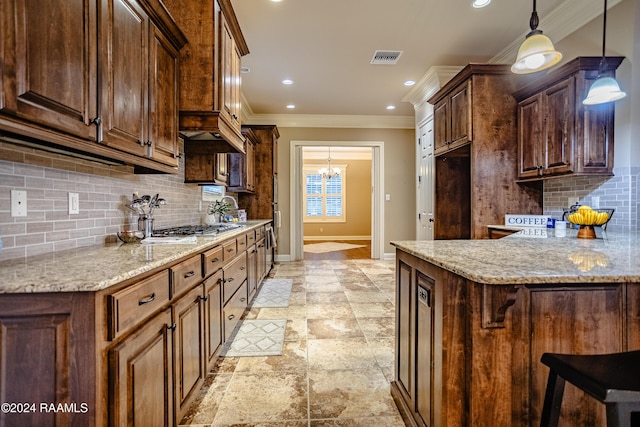 100 Giverny Pl, Lafayette, LA 70508 - kitchen featuring crown molding, stone tile flooring, light stone countertops, backsplash, and decorative light fixtures