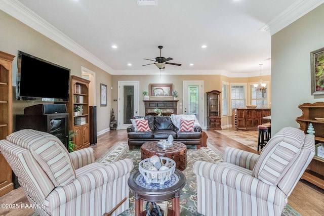 100 Giverny Pl, Lafayette, LA 70508 - living area with a fireplace, recessed lighting, ornamental molding, light wood-style flooring, and a ceiling fan