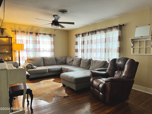 living room with ceiling fan and dark hardwood / wood-style flooring