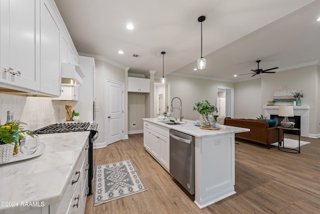 kitchen with sink, white cabinetry, dishwasher, and an island with sink