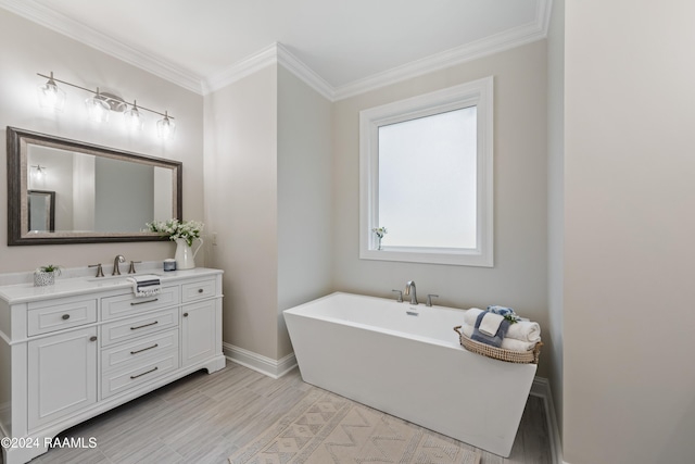 bathroom with hardwood / wood-style flooring, ornamental molding, a bathing tub, and vanity