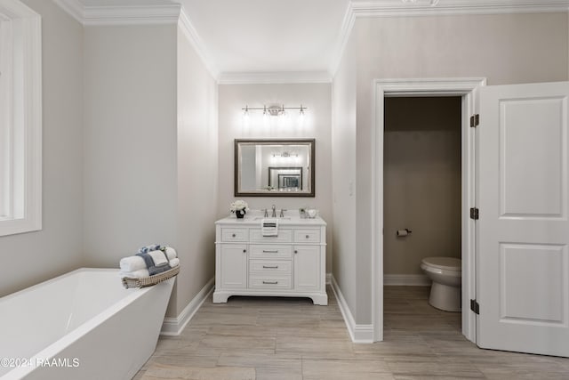 bathroom with a tub, toilet, vanity, and crown molding