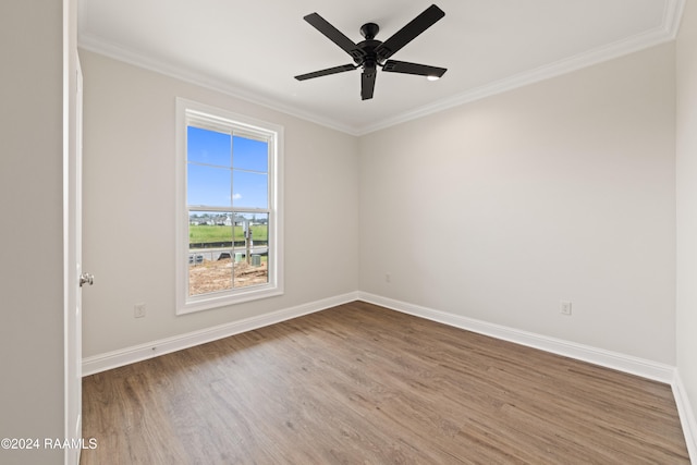 spare room with ceiling fan, crown molding, and wood-type flooring