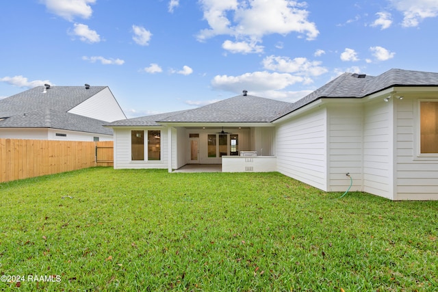 back of house featuring ceiling fan, a yard, and a patio