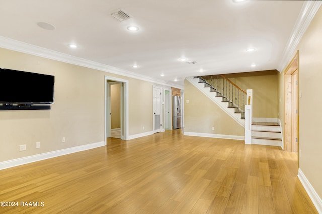 interior space featuring crown molding and light hardwood / wood-style floors