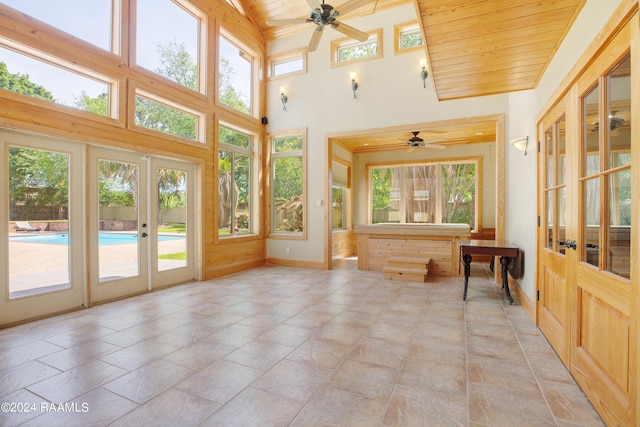 sunroom / solarium with ceiling fan, french doors, and wood ceiling