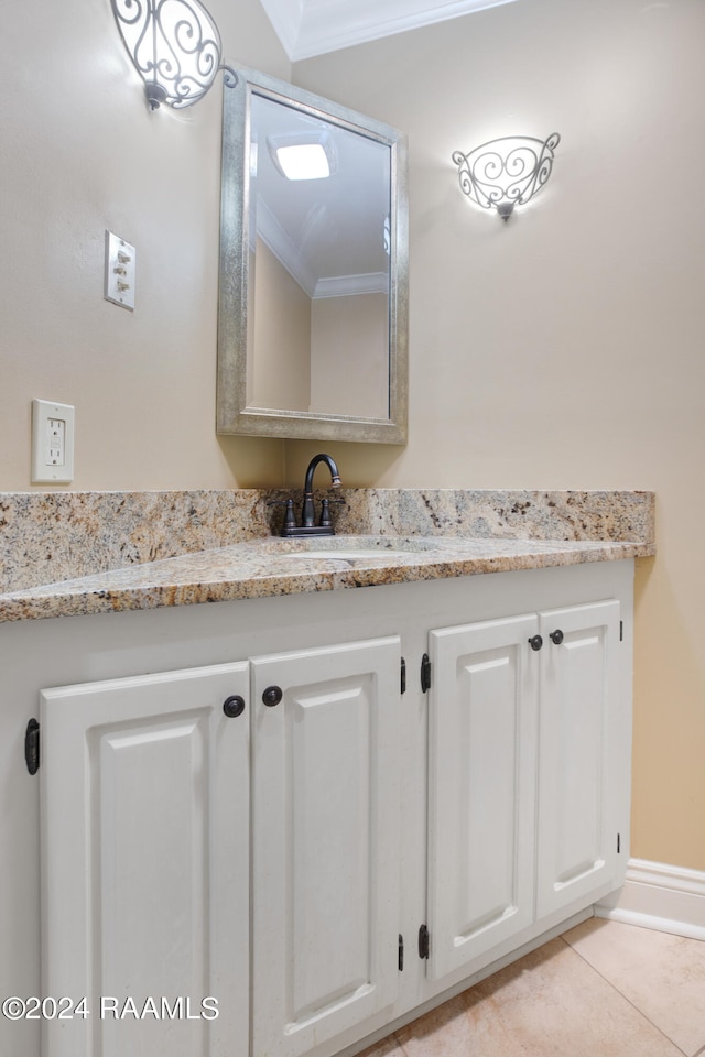 bathroom with ornamental molding, vanity, and tile floors