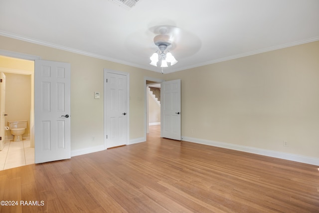 interior space with ceiling fan and crown molding