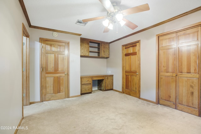 unfurnished bedroom featuring carpet floors, ceiling fan, and ornamental molding