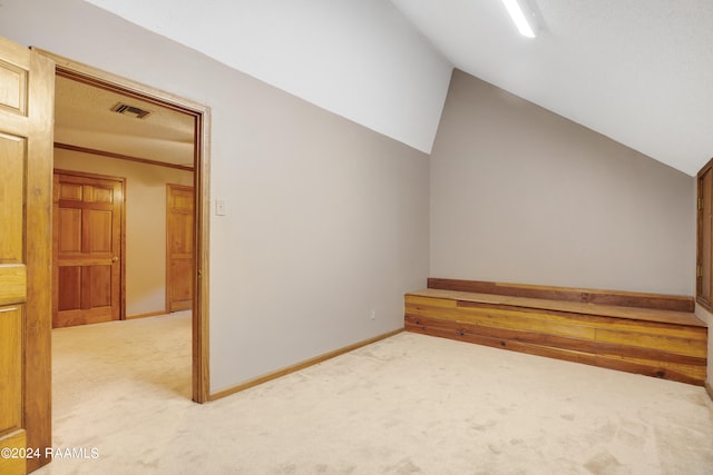 bonus room featuring vaulted ceiling and carpet flooring