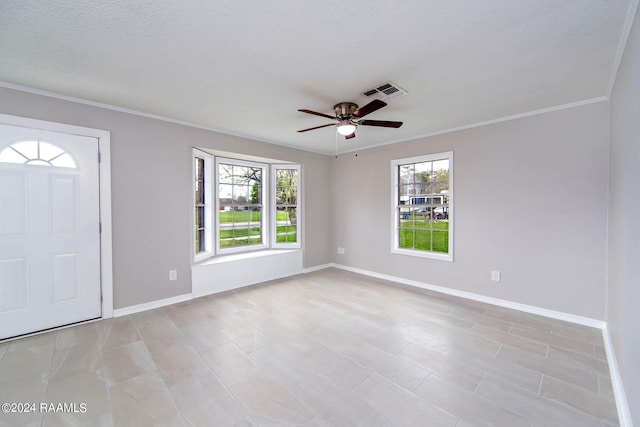 foyer entrance with ceiling fan, ornamental molding, light tile floors, and a textured ceiling