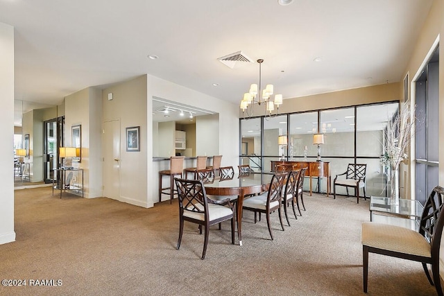 dining area with baseboards, a notable chandelier, visible vents, and carpet flooring