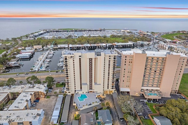 aerial view at dusk featuring a water view