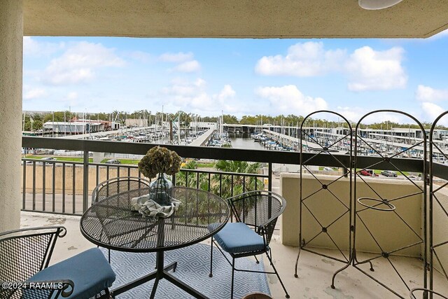 balcony featuring a water view