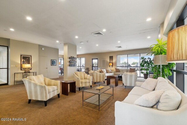 living room featuring carpet floors, visible vents, and recessed lighting