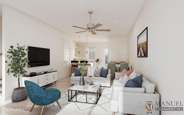 living room with ceiling fan and light wood-type flooring